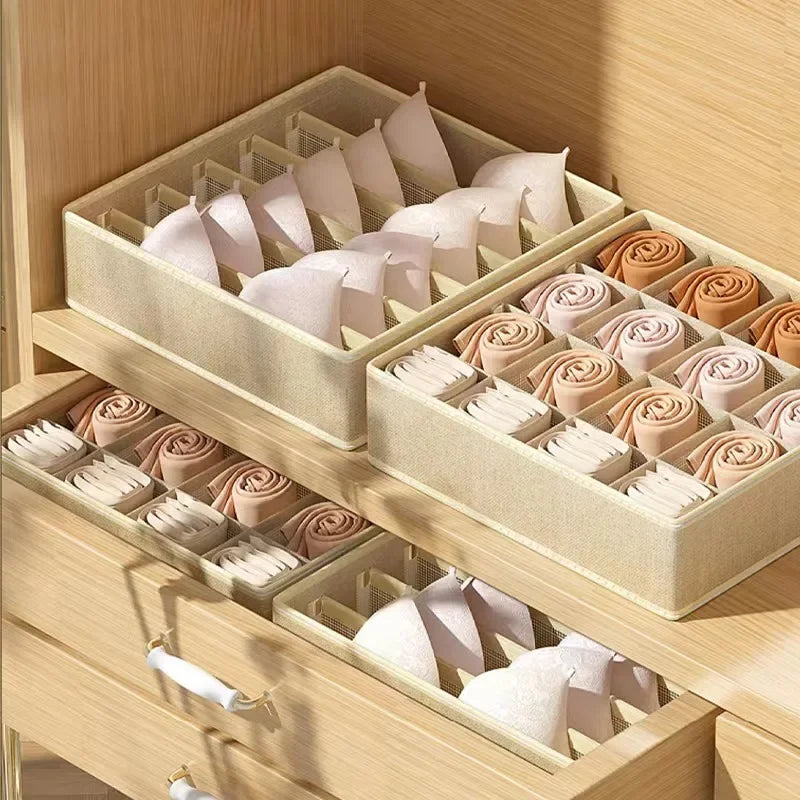 Neat wardrobe drawers with beige mesh organizers for minimalist bedroom organization