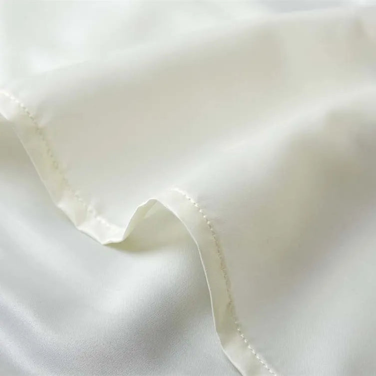 Close-up of envelope closure design on a mulberry silk pillowcase.
